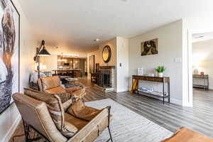 Living area featuring wood finished floors, a textured ceiling, and a chandelier