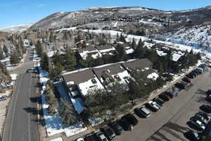 Snowy aerial view featuring a mountain view