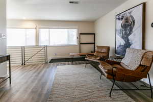 Living area with wood finished floors and a textured ceiling