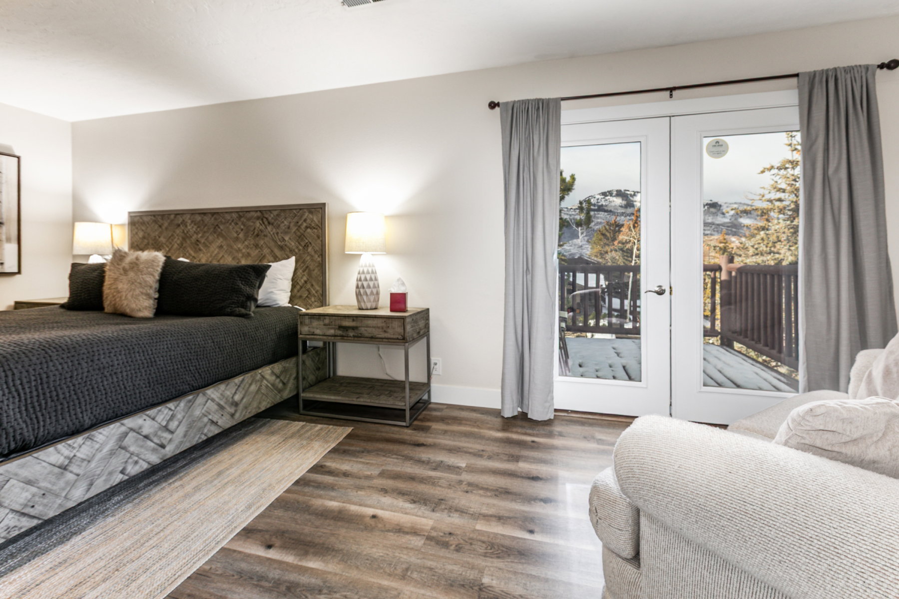 Bedroom with french doors, access to outside, and wood finished floors