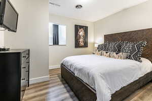 Bedroom featuring baseboards and wood finished floors