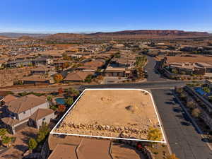 Aerial perspective of suburban area with mountains and property boundaries highlighted
