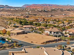 Aerial perspective of suburban area featuring a mountain backdrop