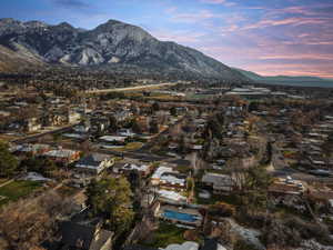 Aerial view of property's location featuring a mountain backdrop and nearby suburban area