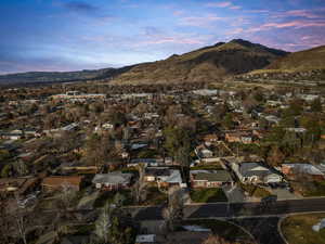 Aerial overview of property's location featuring mountains and nearby suburban area