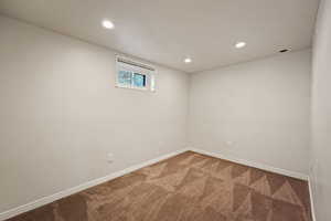 Empty room with carpet floors and recessed lighting