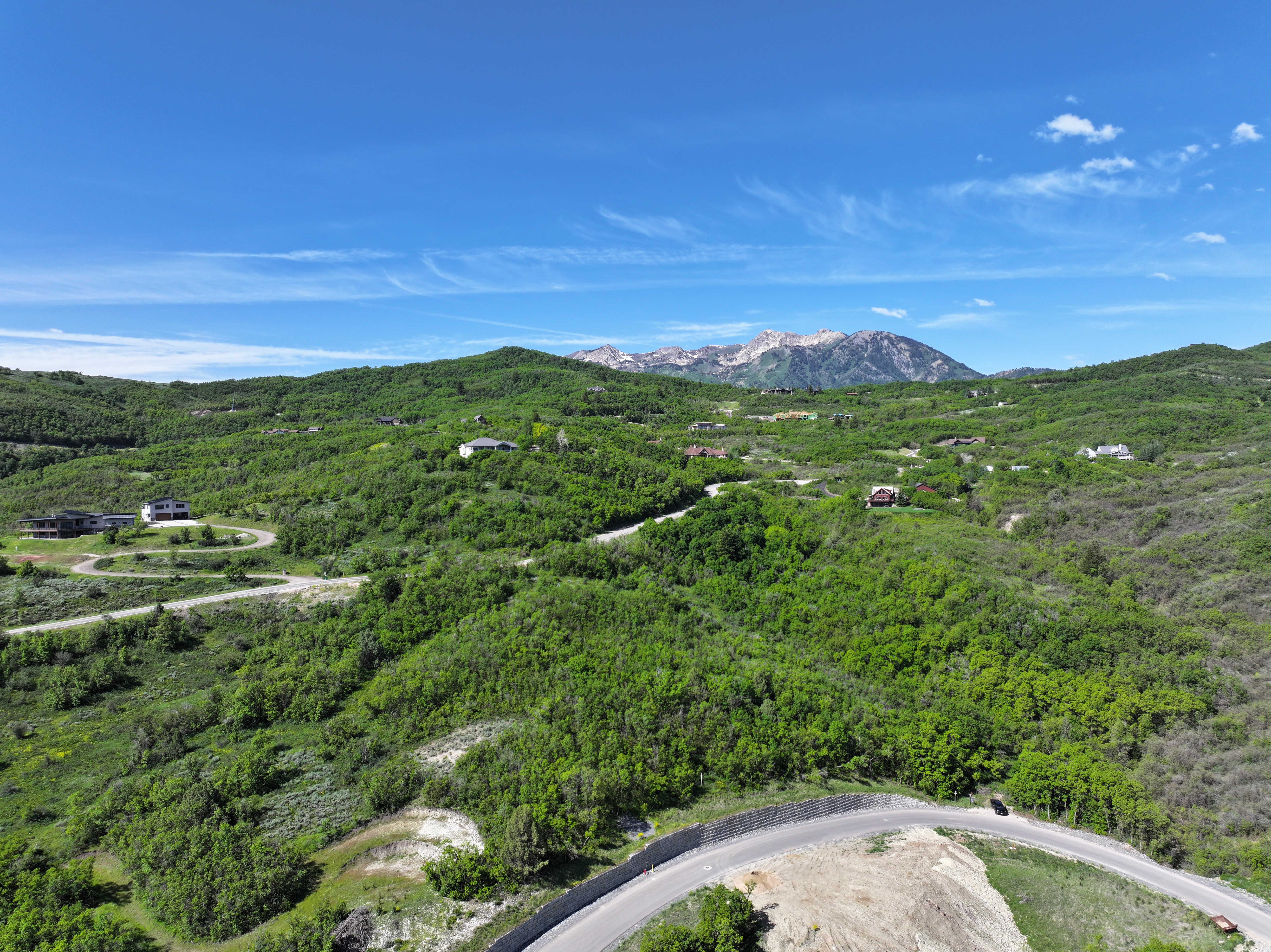 Expansive hillside landscape featuring a winding paved road