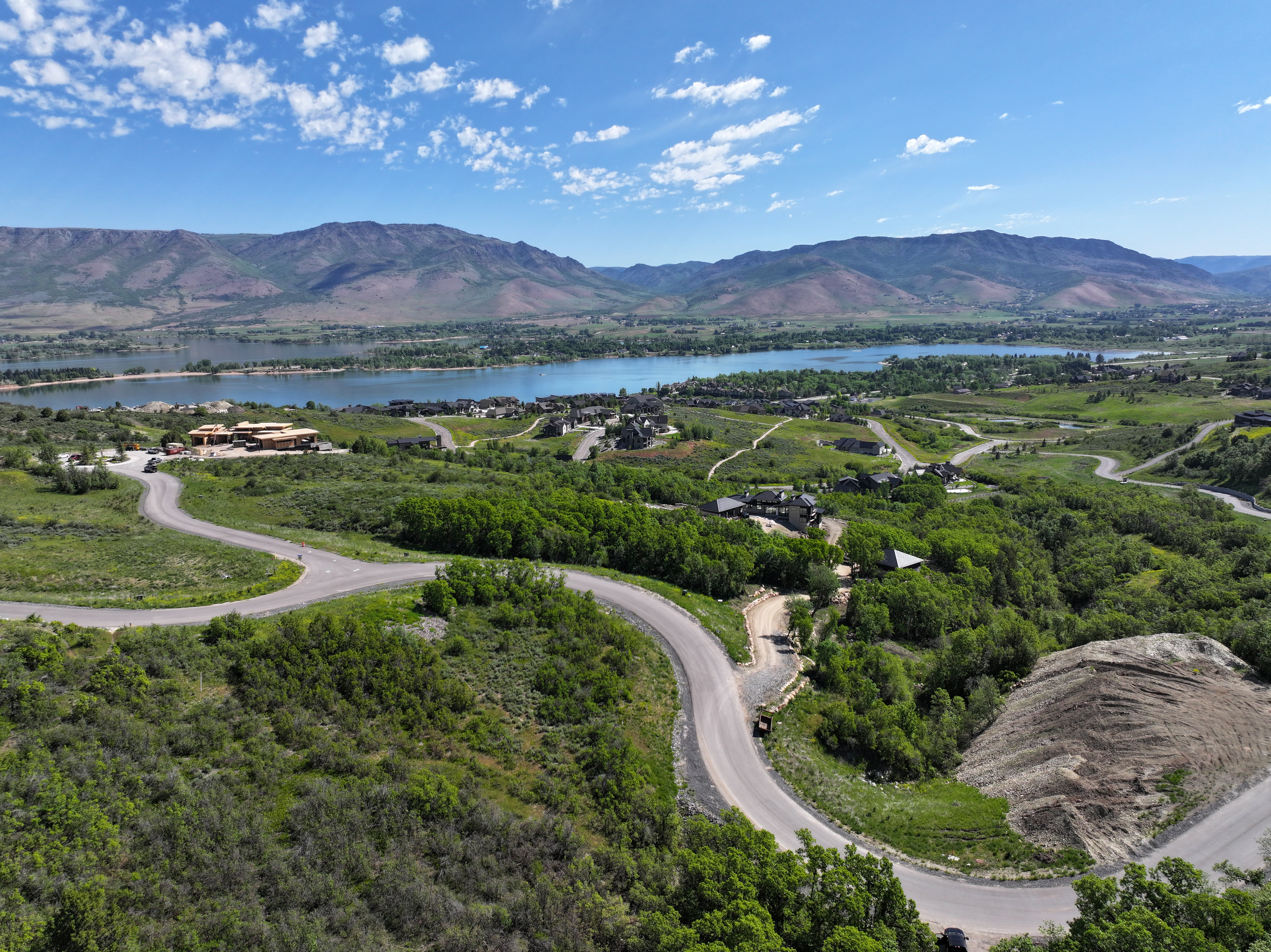 Sweeping mountain and water scenery with a winding paved road