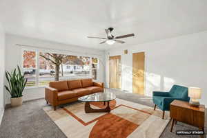 Living room with carpet flooring and a ceiling fan