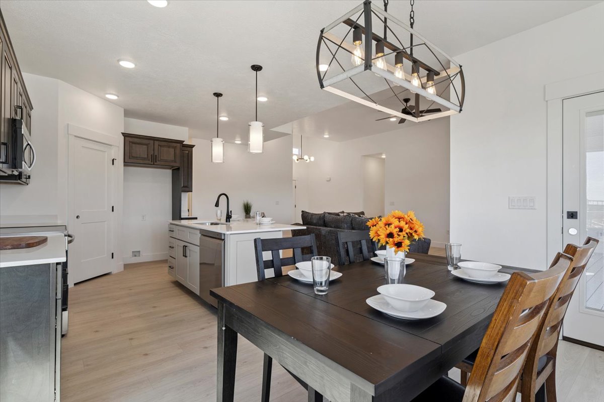 Dining room with light wood-type flooring and recessed lighting