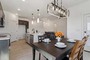 Dining room with light wood-type flooring and recessed lighting