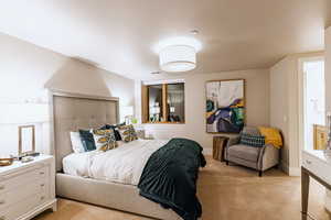 Bedroom featuring carpet flooring and baseboards