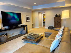 Living room featuring recessed lighting and a tray ceiling