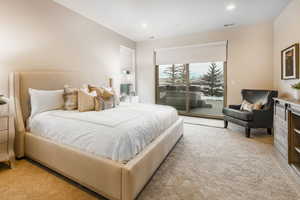Bedroom with light colored carpet, access to exterior, and recessed lighting