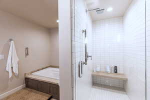Bathroom featuring a stall shower, a bath, recessed lighting, and light tile patterned floors