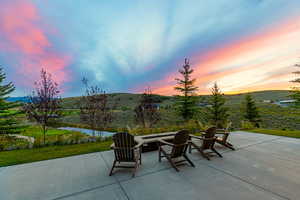 View of patio / terrace featuring a fire pit and a water view