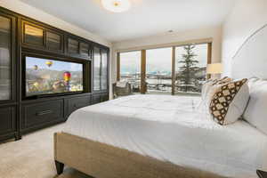 Bedroom with access to outside and light colored carpet
