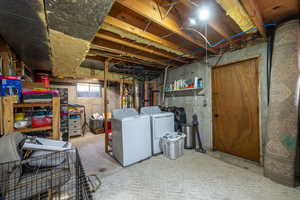 Below grade area featuring washing machine and clothes dryer