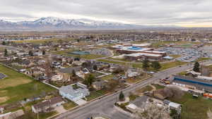 Aerial view of property's location with mountains and nearby suburban area