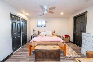 Bedroom with wood finished floors, ceiling fan, a closet, a textured ceiling, and recessed lighting