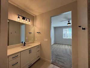 Bathroom with vanity, ceiling fan, and light colored carpet