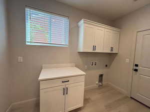 Laundry area featuring washer hookup, hookup for an electric dryer, and cabinet space