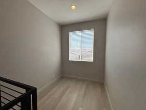 Unfurnished room with light wood-type flooring and baseboards