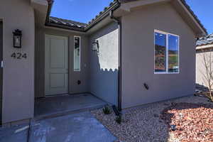 Entrance to property featuring stucco siding and a tiled roof