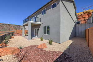 Back of property with a patio, a fenced backyard, and stucco siding