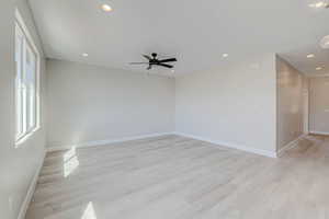 Spare room featuring light wood-style flooring, recessed lighting, and a ceiling fan