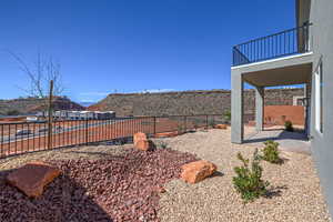 Fenced backyard featuring a patio area and a mountain view