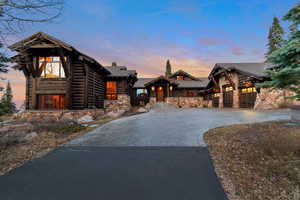 View of front facade featuring stone siding and decorative driveway
