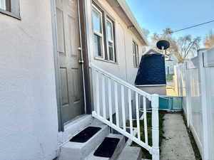 Entrance to property with stucco siding