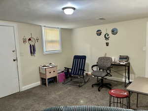 Office area featuring baseboards and carpet