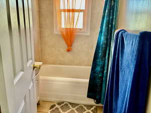 Full bath featuring shower / bath combo with shower curtain