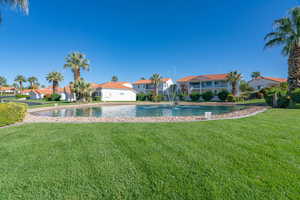 Pond featuring a residential view and a lawn