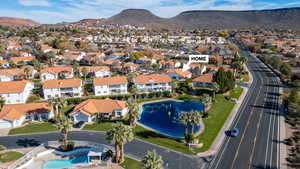 Aerial overview of property's location with mountains and nearby suburban area