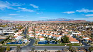 Aerial view of property's location featuring nearby suburban area and mountains