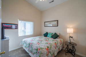 2nd Bedroom featuring vaulted ceiling, carpet flooring, and ceiling fan
