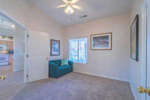 3rd Bed/Den featuring vaulted ceiling, a ceiling fan, and light colored carpet
