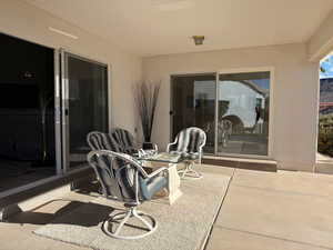 View of covered patio with lighting above.