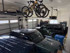 View of garage, with high ceilings and storage racks