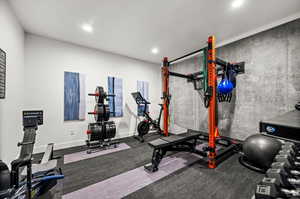 Exercise room with recessed lighting and baseboards
