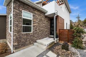 Property entrance featuring stone siding