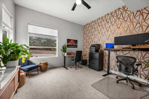 Office with an accent wall, light carpet, a ceiling fan, and wallpapered walls