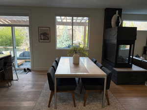 Dining space with a fireplace and hardwood / wood-style flooring