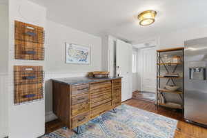 Kitchen with wainscoted wall, and dark wood-style flooring, seperate entrance from ADU