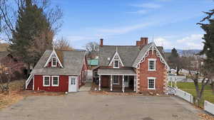 Victorian-style home featuring a covered porch