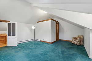 Additional living space up stairs at cottage featuring lofted ceiling, bathroom small kitchenette.