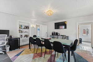 Dining space featuring an office area and light wood finished floors